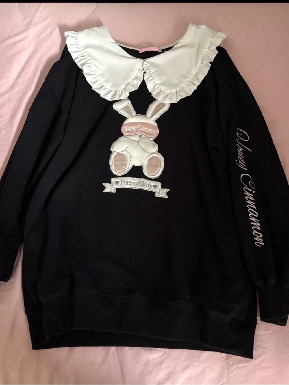 This is the Honey Cinnamon rabbit-applique sweatshirt featuring a ruffled white